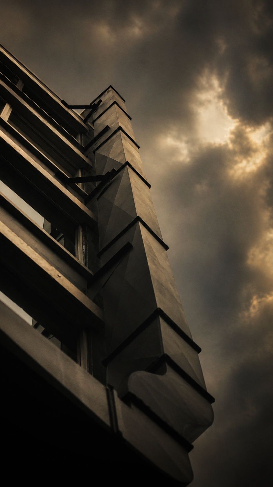 A fire escape against a burning sky